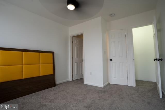 unfurnished bedroom with carpet flooring and a closet