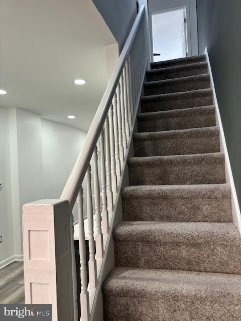 2614 Grogan Ave, Baltimore, MD 21213 - stairway with wood finished floors, recessed lighting, and baseboards