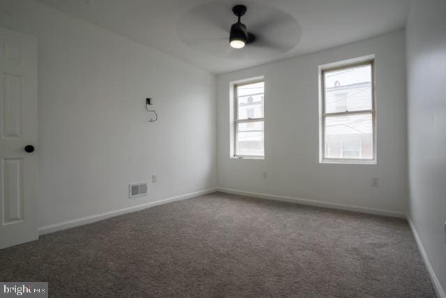 empty room with carpet flooring and ceiling fan