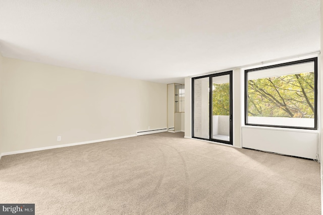 carpeted spare room featuring a baseboard radiator