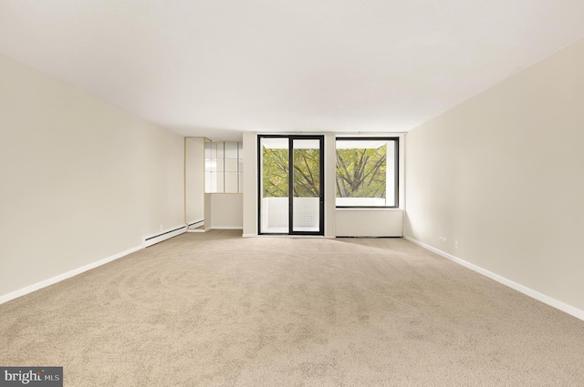 carpeted spare room featuring a baseboard radiator