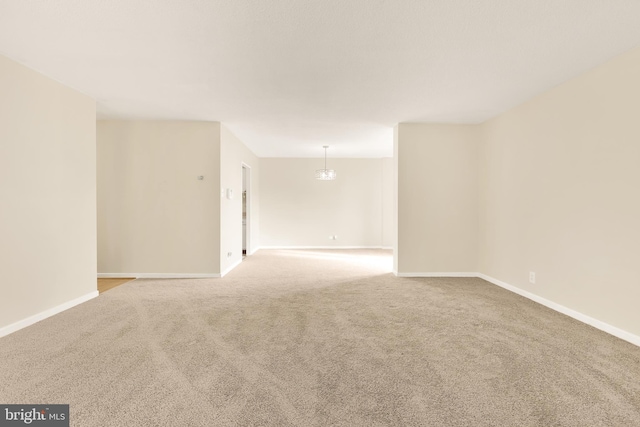 spare room featuring light carpet