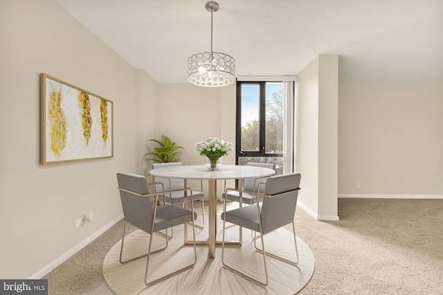 dining space featuring carpet floors and a notable chandelier