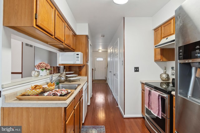 kitchen with dark hardwood / wood-style flooring, sink, and stainless steel appliances