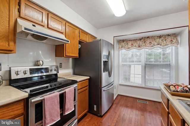 kitchen featuring stainless steel appliances and dark wood-type flooring