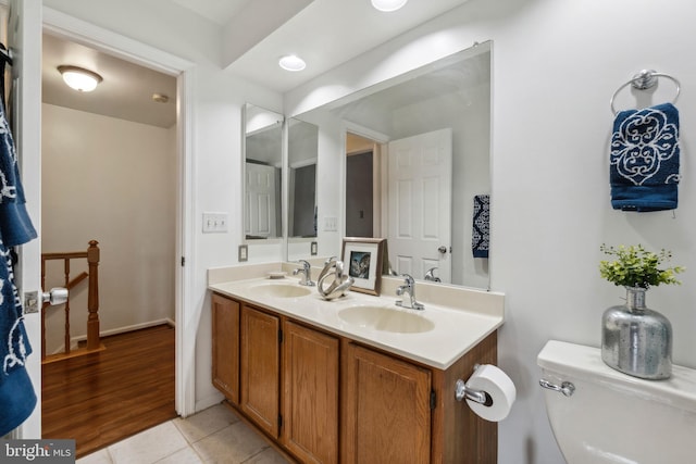 bathroom featuring tile patterned flooring, vanity, and toilet