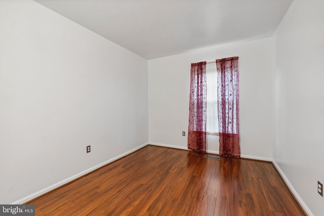 empty room featuring dark wood-type flooring