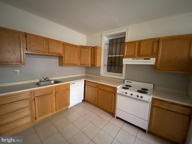 kitchen featuring white appliances, sink, and light tile patterned floors