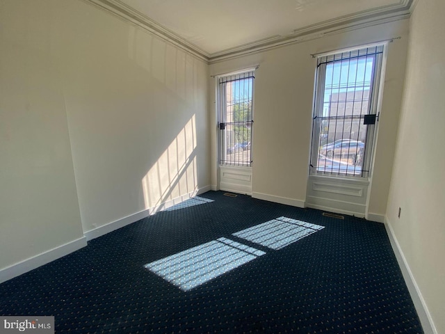 carpeted spare room with crown molding