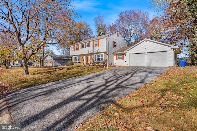 90 Torrington Ln, Willingboro, NJ 08046 - colonial-style house featuring driveway, an attached garage, a front lawn, and stone siding