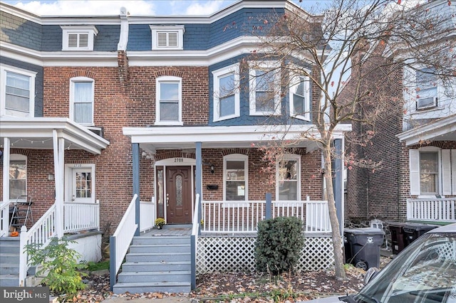 townhome / multi-family property with covered porch