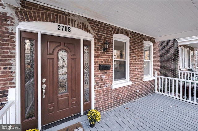 view of exterior entry with covered porch