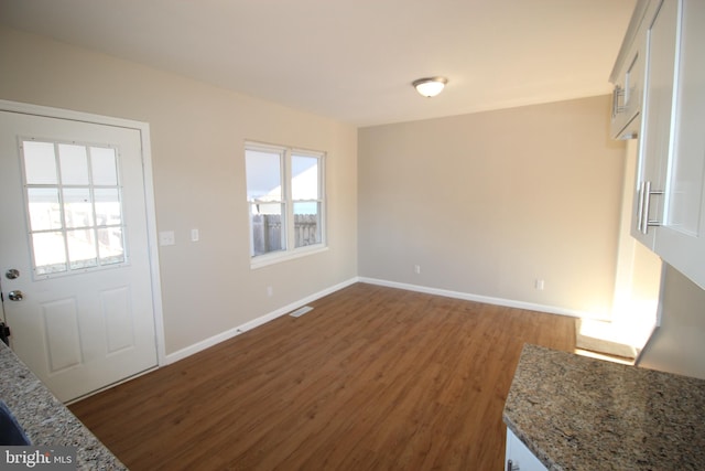 interior space with a healthy amount of sunlight and dark hardwood / wood-style flooring