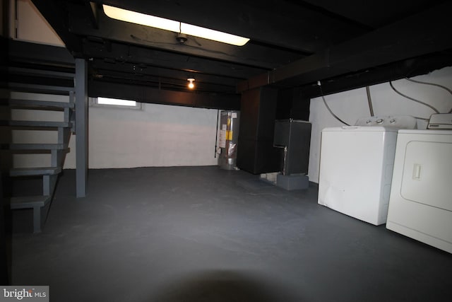 basement featuring gas water heater and separate washer and dryer