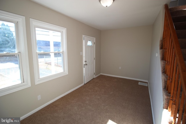 view of carpeted foyer entrance