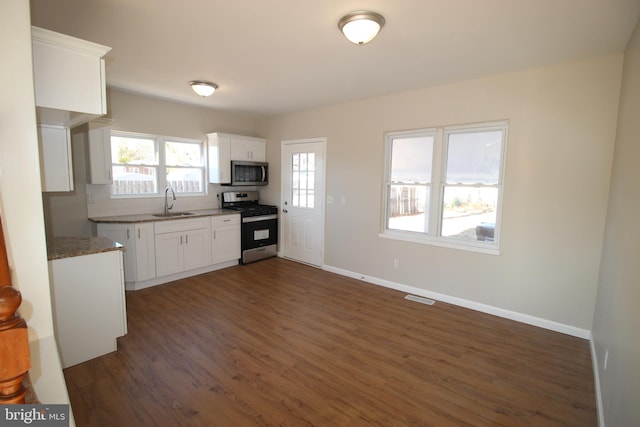 kitchen featuring white cabinetry, sink, appliances with stainless steel finishes, tasteful backsplash, and dark hardwood / wood-style floors