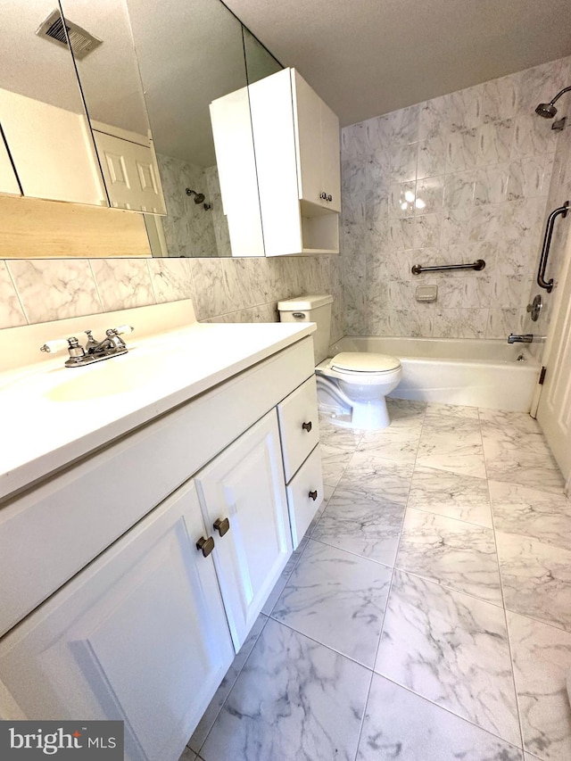 full bathroom with toilet, vanity, tiled shower / bath, and a textured ceiling