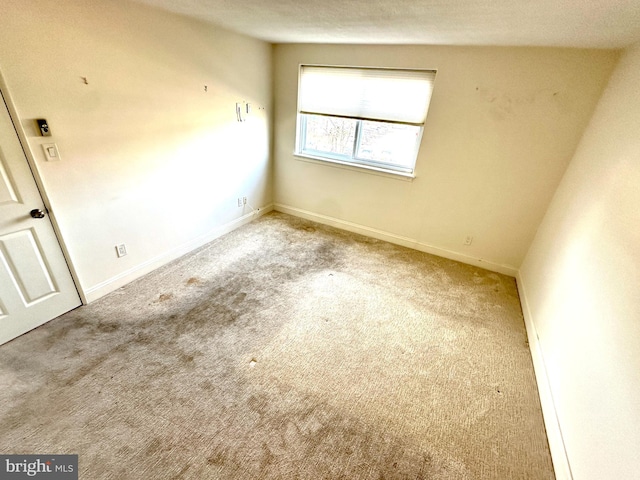 carpeted spare room featuring a textured ceiling