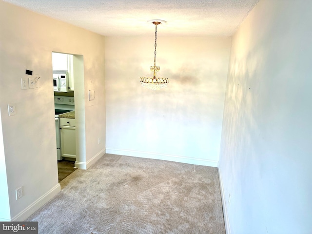 empty room featuring a textured ceiling and carpet floors