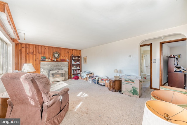 carpeted living room with wooden walls