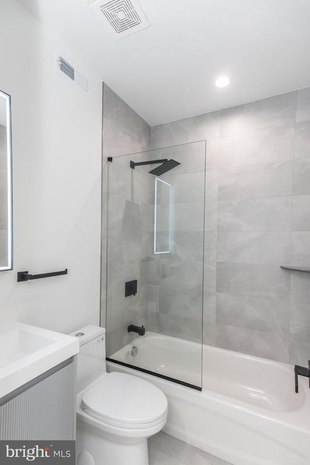 full bathroom with shower / bath combination with glass door, vanity, and toilet