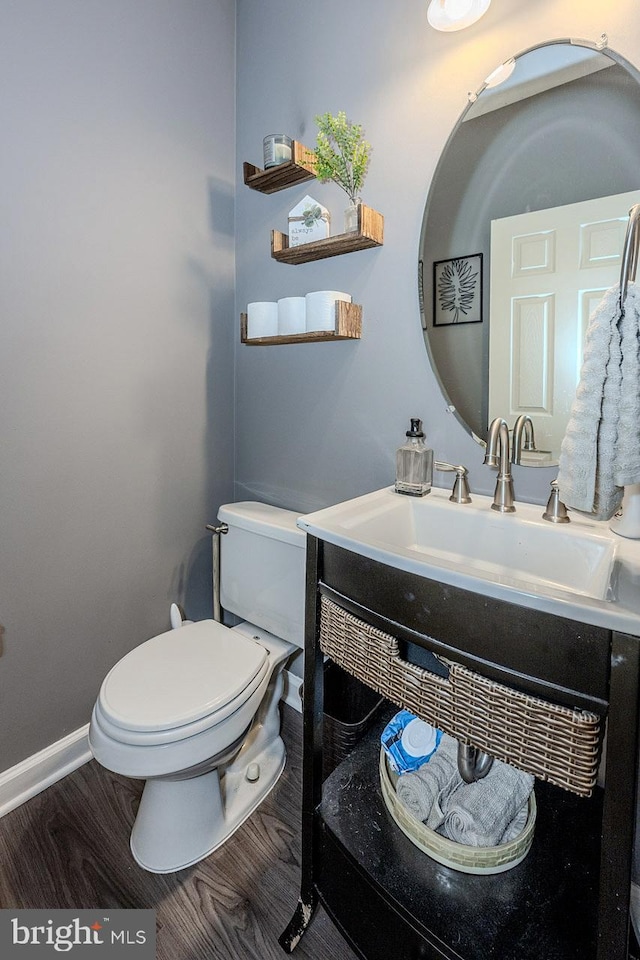 bathroom featuring hardwood / wood-style floors, vanity, and toilet