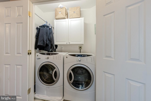 clothes washing area with cabinets and independent washer and dryer