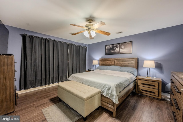 bedroom with ceiling fan and dark hardwood / wood-style flooring