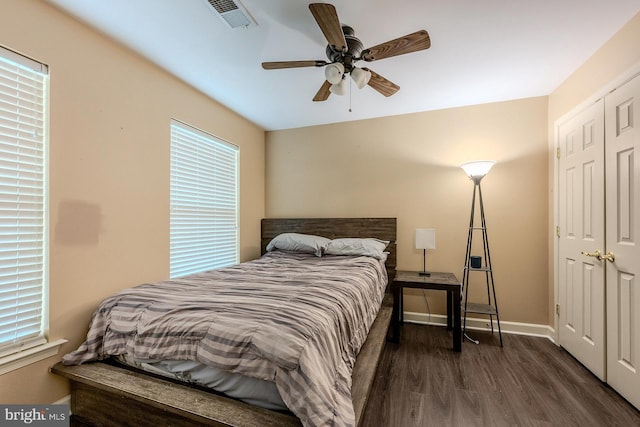 bedroom with ceiling fan and dark wood-type flooring