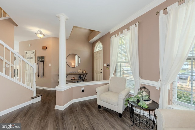 living area with decorative columns, plenty of natural light, and dark wood-type flooring