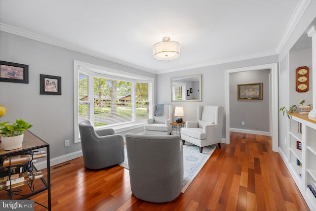 living room featuring dark wood-type flooring and ornamental molding