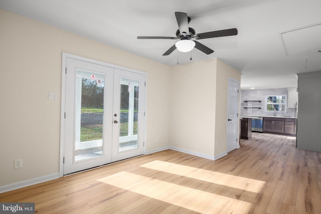 spare room with french doors, ceiling fan, and light hardwood / wood-style flooring