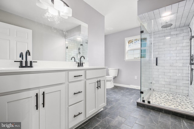 bathroom with vanity, toilet, and an enclosed shower