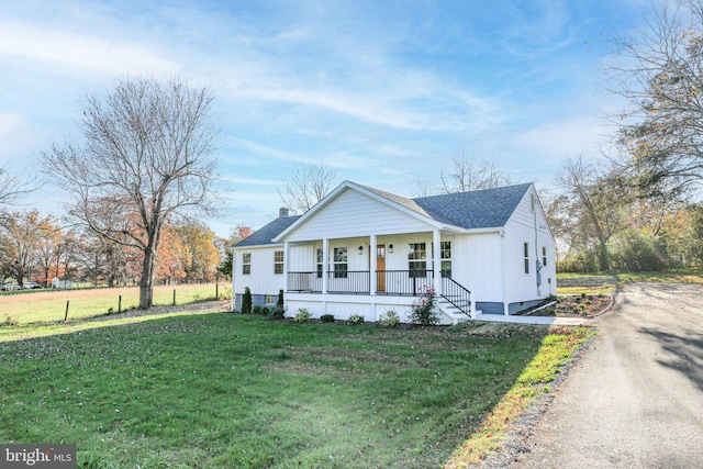 view of front of house with a front lawn and a porch