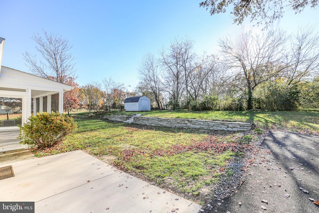 view of yard with a shed and a patio