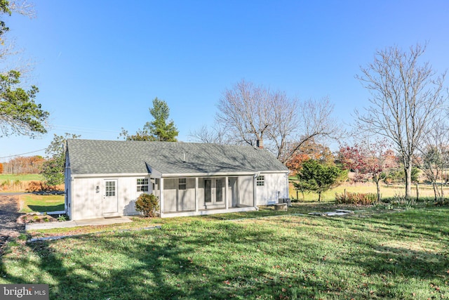 rear view of property with a lawn