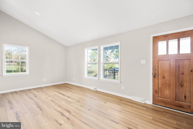 foyer with light hardwood / wood-style flooring and vaulted ceiling