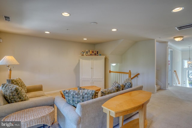 living room featuring light colored carpet and an inviting chandelier