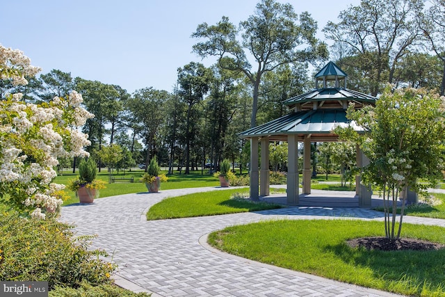 view of property's community with a lawn and a gazebo