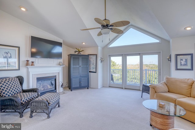 carpeted living room with high vaulted ceiling and ceiling fan