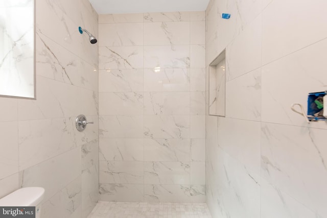 bathroom with tiled shower