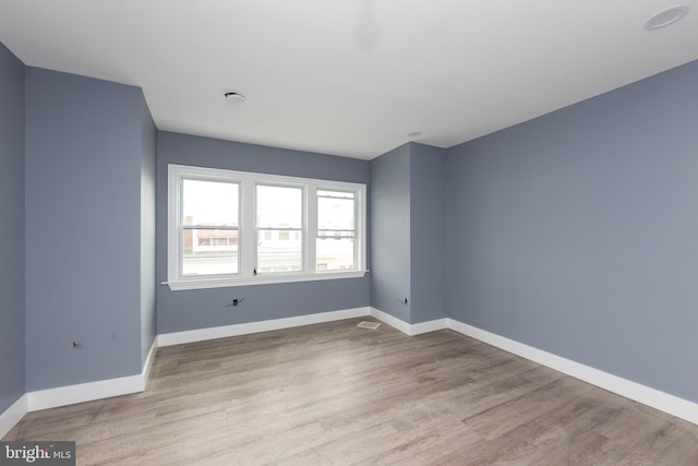 unfurnished room featuring light hardwood / wood-style floors