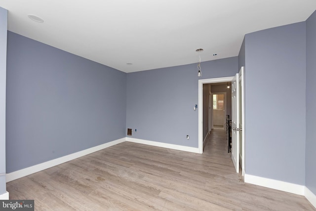 unfurnished room with light hardwood / wood-style flooring