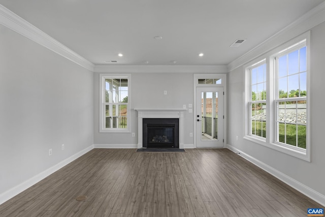 unfurnished living room featuring dark wood-type flooring and crown molding