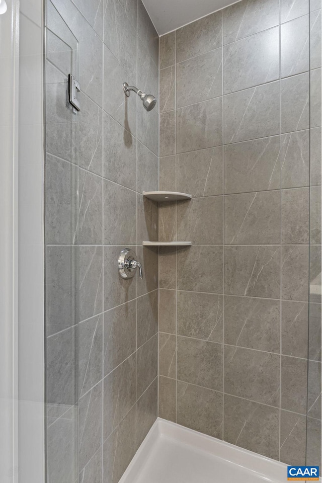 bathroom with a tile shower