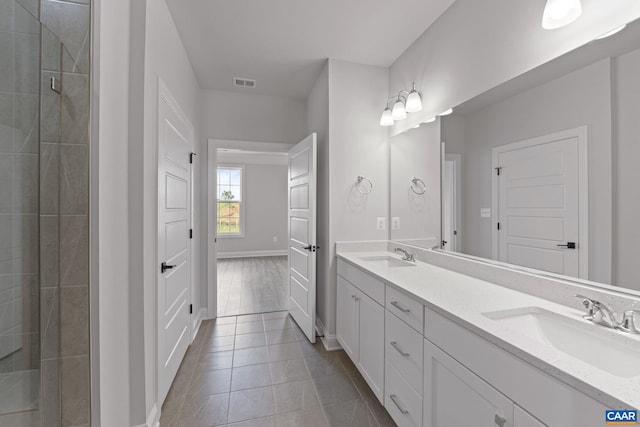 bathroom featuring vanity, tile patterned floors, and a shower with door