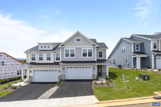 view of front of home featuring a garage, cooling unit, and a front yard