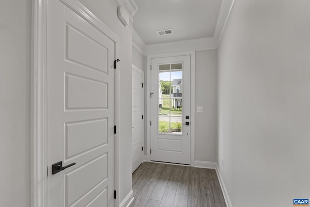 entryway featuring light wood-type flooring and ornamental molding