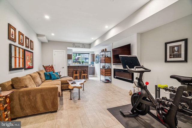 workout area featuring light hardwood / wood-style floors and indoor bar