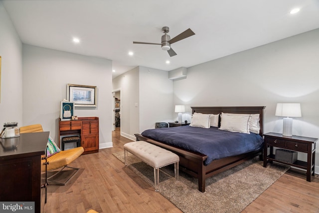 bedroom with light hardwood / wood-style flooring and ceiling fan